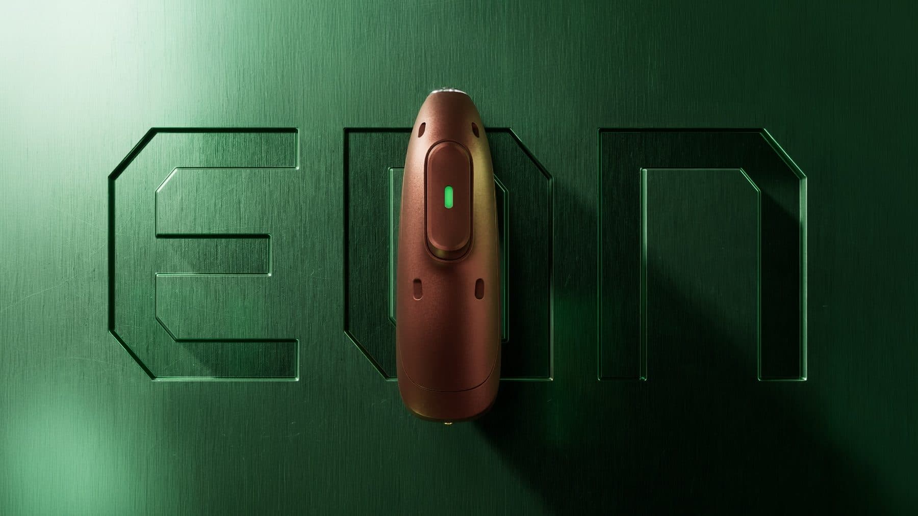 The Phonak Audéo EON hearing aid set into an engraved EON logo on green metal