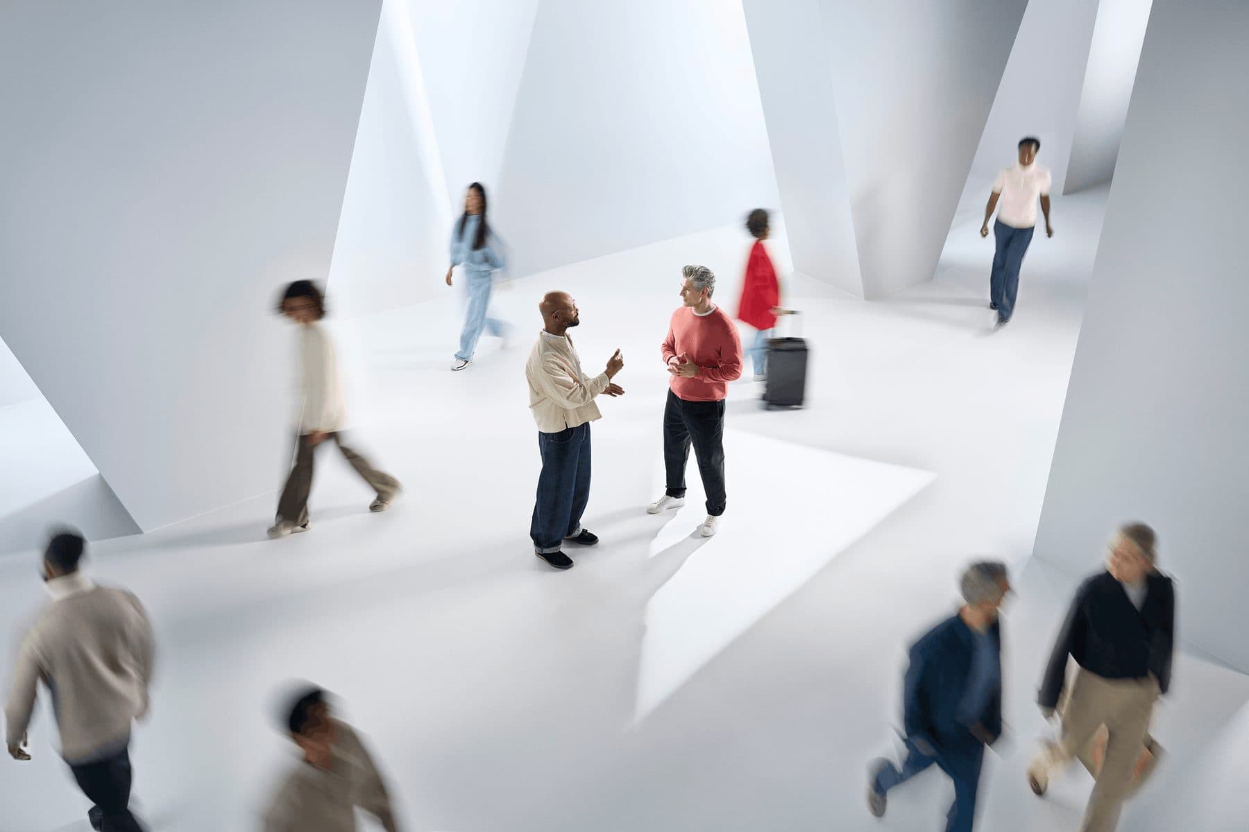 People walking through a bright, busy modern space